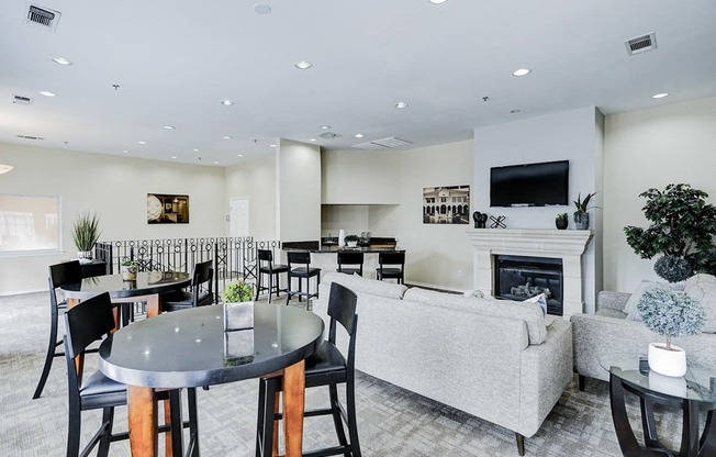 a living room with a fireplace and a table and chairs