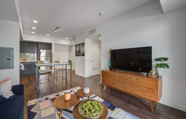 A modern living room with a wooden coffee table and a flat screen TV.