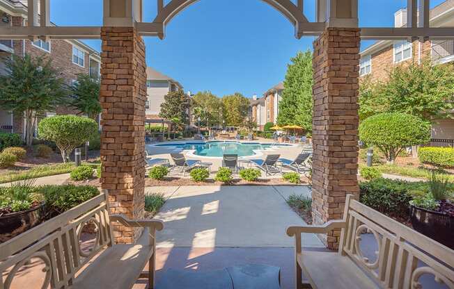 a view of a swimming pool from a patio with benches