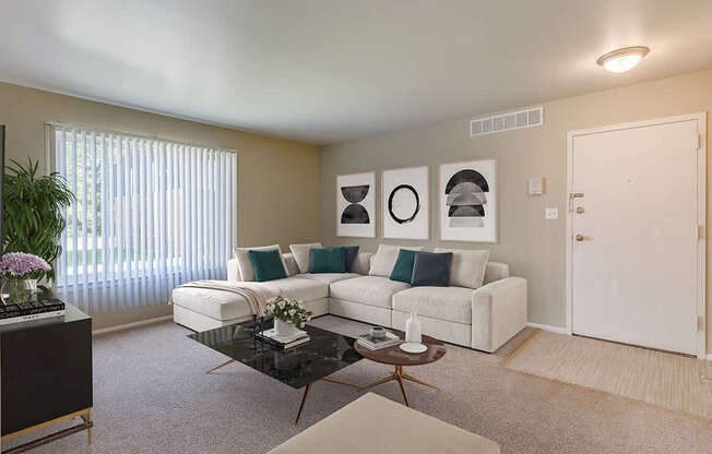 A living room with a white couch, a black coffee table, and a plant on the left side.