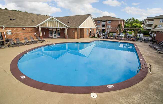 A large outdoor swimming pool with a brown border.