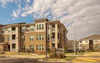 A large apartment complex with a sign that says Clairmont Schenectady.