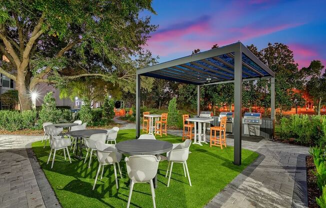 a patio with tables and chairs and a pergola