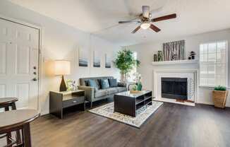 Sophisticated Living Room Remodel With Fireplace at Wildwood Apartments, CLEAR Property Management, Texas, 78752