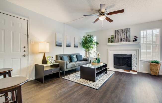 Sophisticated Living Room Remodel With Fireplace at Wildwood Apartments, CLEAR Property Management, Texas, 78752