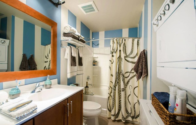 a bathroom with a sink toilet and shower and a mirror at Ann Arbor City Club, Ann Arbor, MI 48104