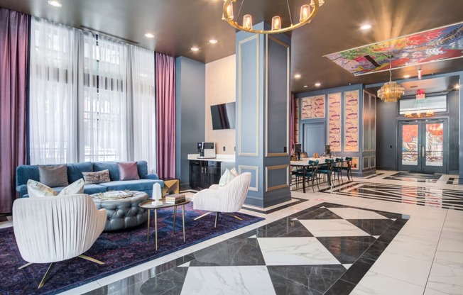 a lobby with blue and white furniture and a large chandelier