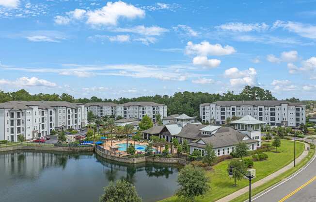 an aerial view of the resort with a lake and buildings