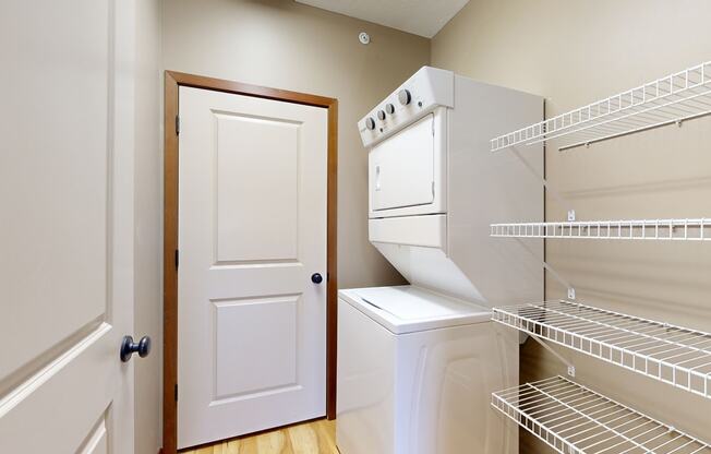 the walk in pantry and laundry space with a door to the mechanical room