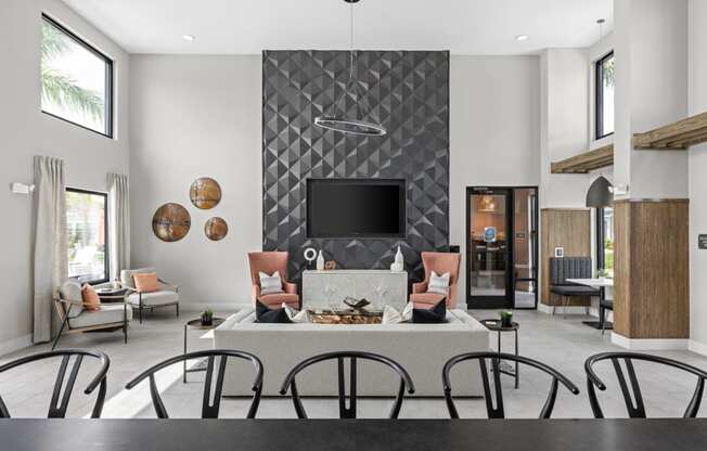 a living room with a fireplace and a table with chairs at The Sophia, Venice, FL, 34275