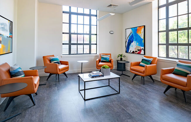 a living room with orange chairs and a coffee table