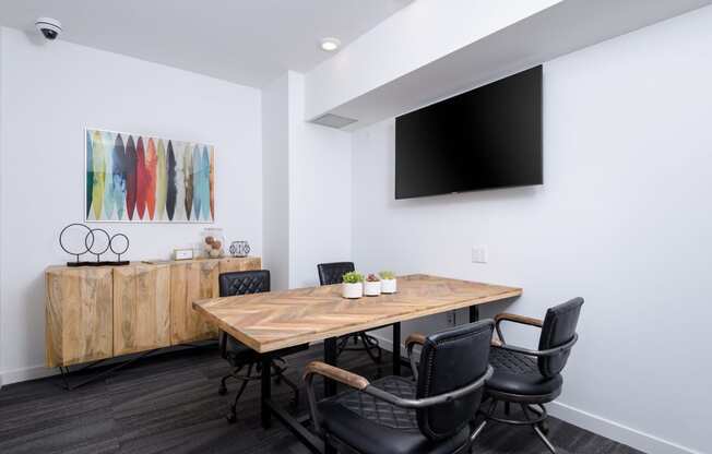 Collaborative workspace with conference table and television