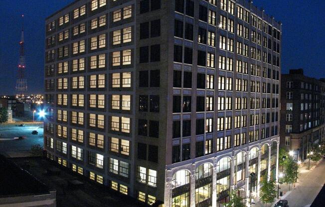 a tall building with many windows at night