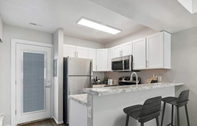 a kitchen with a counter top and a refrigerator