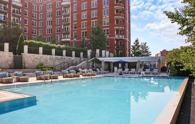 a swimming pool with a hotel in the background