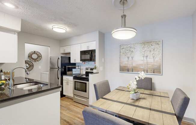 an open kitchen and dining room with a table and chairs