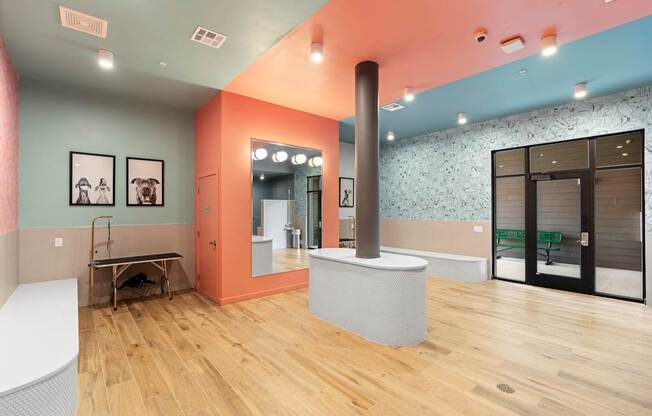 A room with a white table and a mirror on the wall.