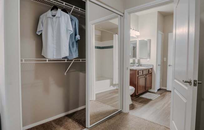 A white closet with a shirt hanging on it.