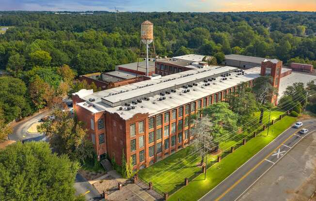an aerial view of a brick building with a roofed facility
