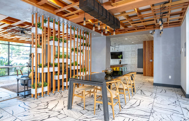 A modern kitchen with a wooden table and chairs.
