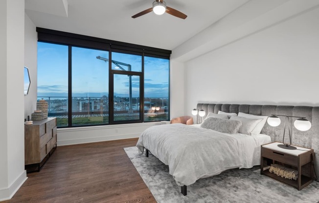 a bedroom with a large bed and a large window at Stanza Little Italy, San Diego, CA