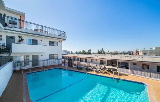 A swimming pool in a sunny outdoor setting.