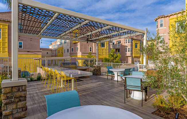 A patio with a table and chairs under a roof.