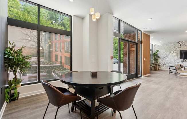A modern dining room with a large table and chairs.
