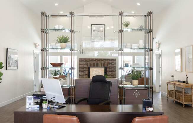 a view of the reception desk with a fireplace in the background and a living room in the