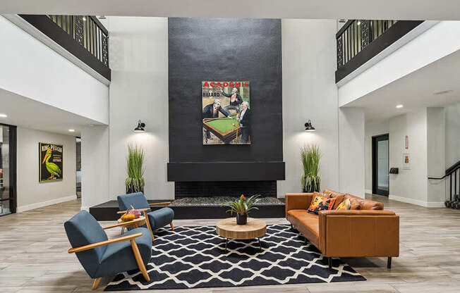 Community Clubhouse with Lounge Furniture and Fireplace at Madison Park Apartments located in Anaheim, CA.