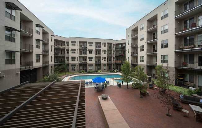 Apartment complex with a pool in the middle at Regatta Sloans Lake Apartments, Denver, CO