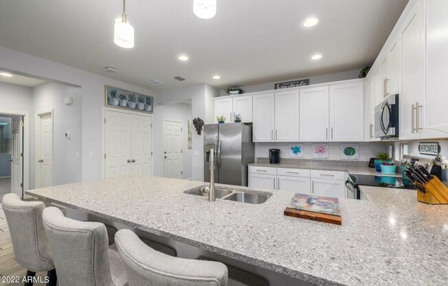 Gorgeous single level 4-bedroom, 3-bathroom home nestled in an upscale gated community in Peoria