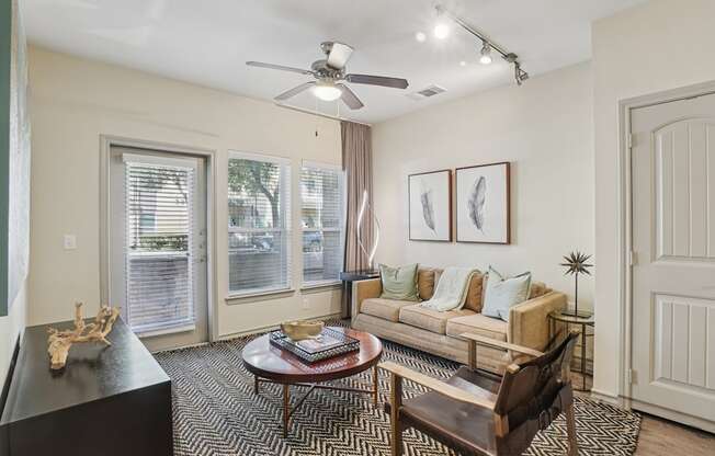 A living room with a black coffee table and a brown chair.