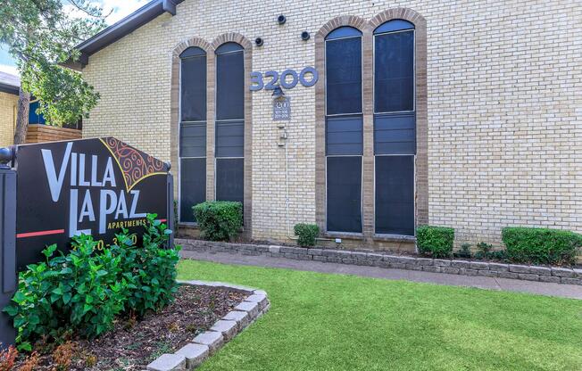 a garden in front of a brick building