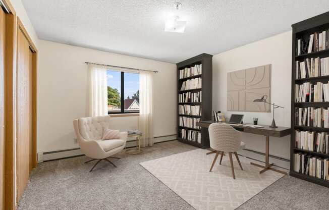 a home office with two chairs and a desk and a window