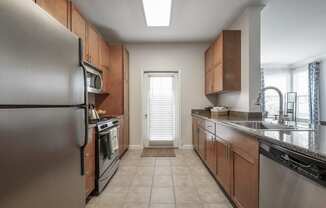 a kitchen with stainless steel appliances and wooden cabinets