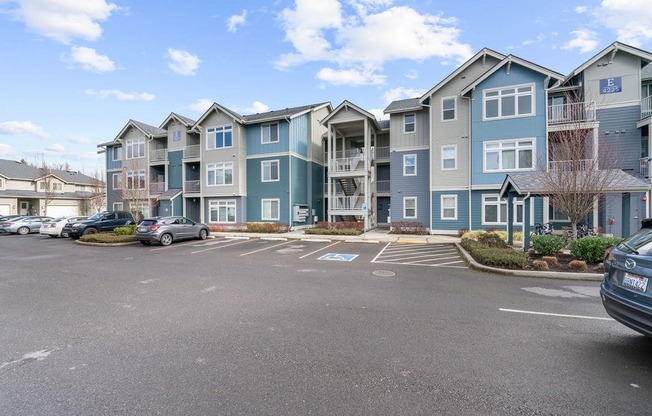 an empty parking lot in front of an apartment complex