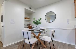 a dining room with a glass table and chairs