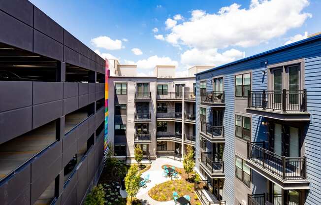 an aerial view of an apartment complex with a pool in the middle