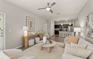 A living room with a white couch and a coffee table.