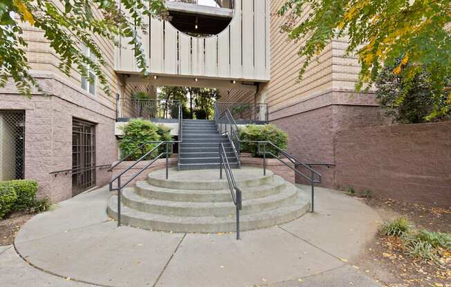 An outdoor staircase at Ten05 West Trade Apartments with a metal railing.