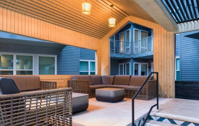 Relax under covered seating at Modera Old Ivy, where warm lighting and refined outdoor spaces offer a polished escape.