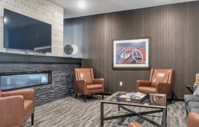 A living room with a fireplace and a painting on the wall.