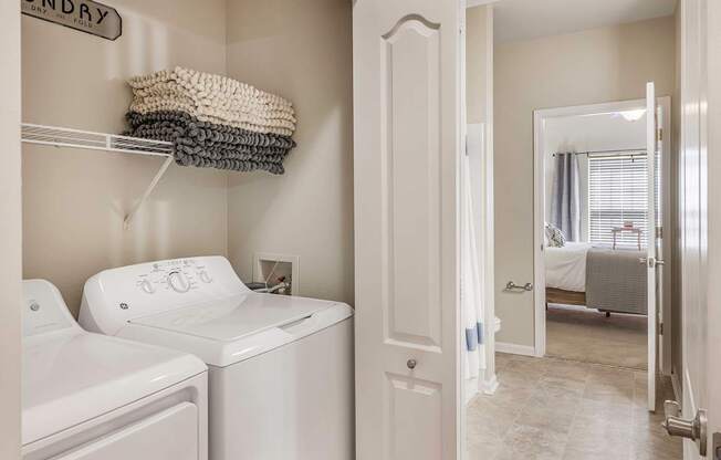 A white washing machine and dryer in a laundry room.