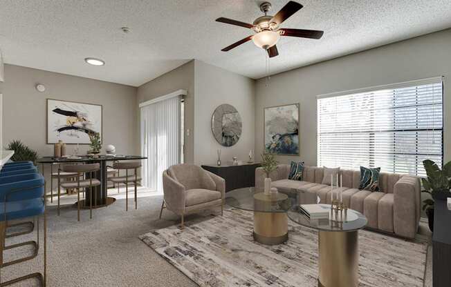 A living room with a beige couch, a coffee table, and a ceiling fan.