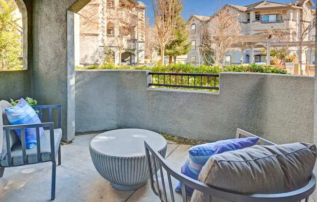 a patio with a couch and chairs and a table