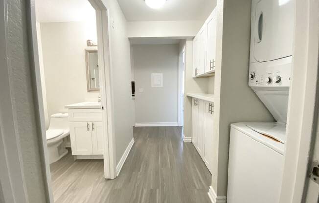 View of laundry with bathroom and storage