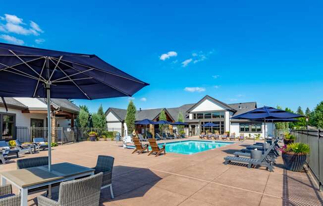 our apartments have a pool and patio with chairs and umbrellas