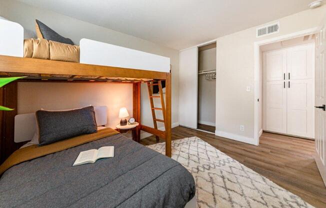 a bedroom with a bunk bed and a rug