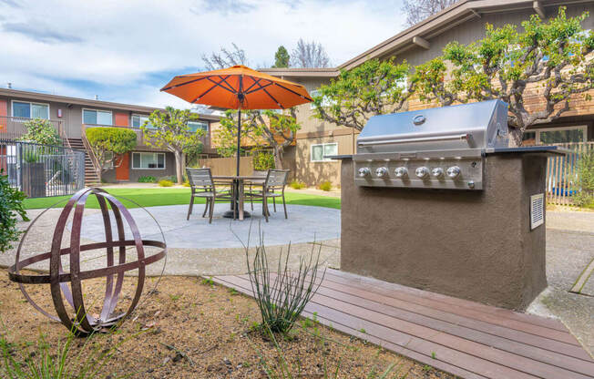 a patio with a grill and a table with an umbrella at Element LLC, Sunnyvale, CA